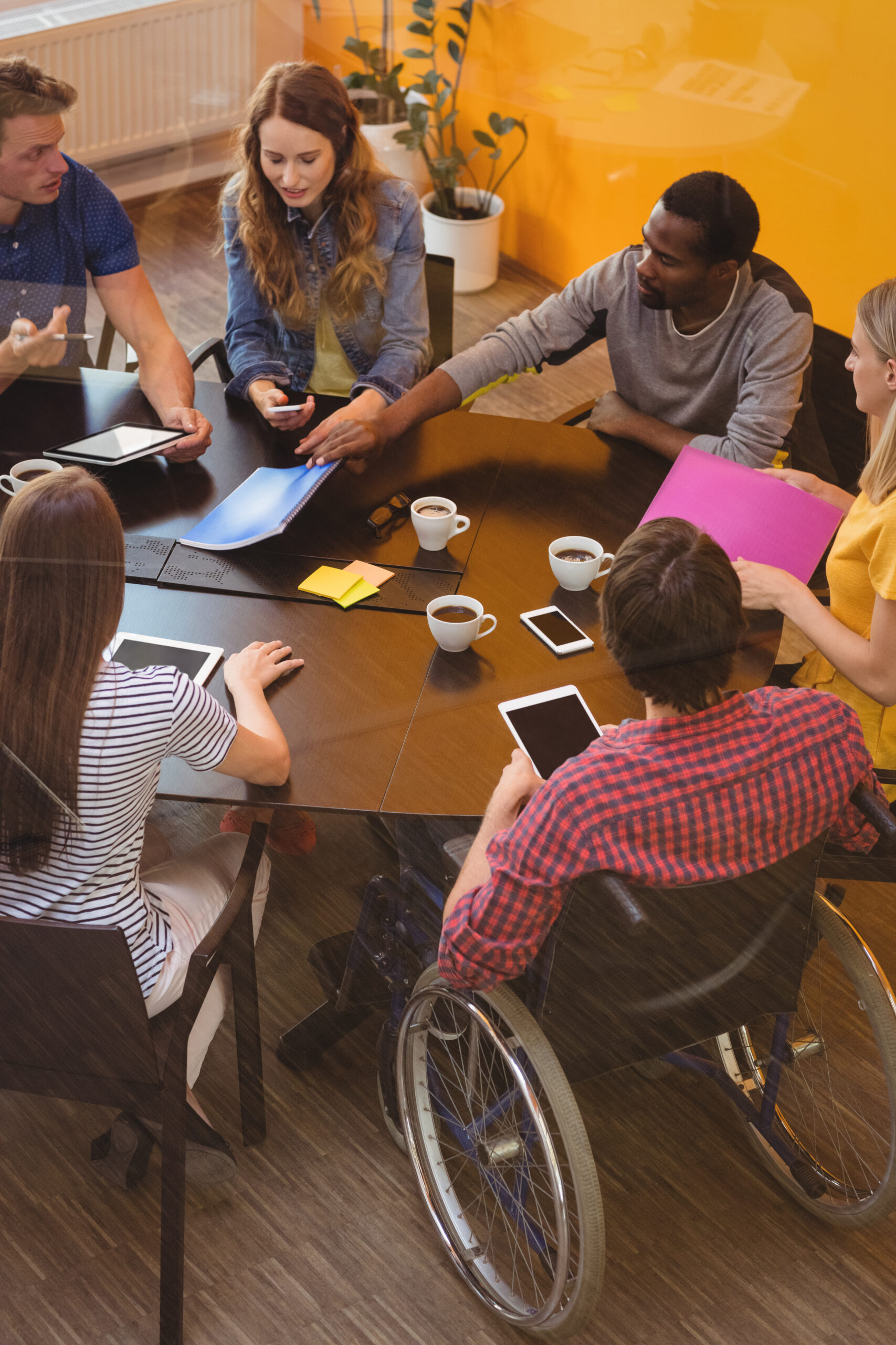 Business executives interacting with each other Business executives interacting with each other during meeting in office